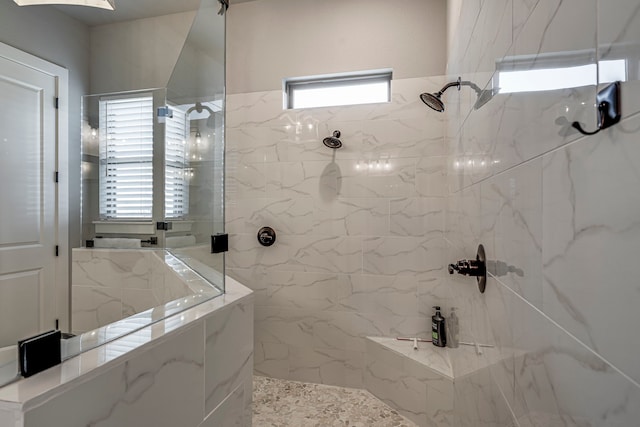 full bathroom featuring a marble finish shower