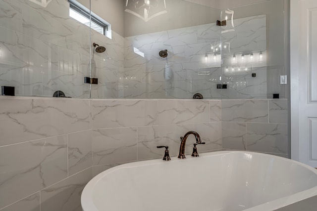 full bathroom with a sink, a walk in shower, and a freestanding bath