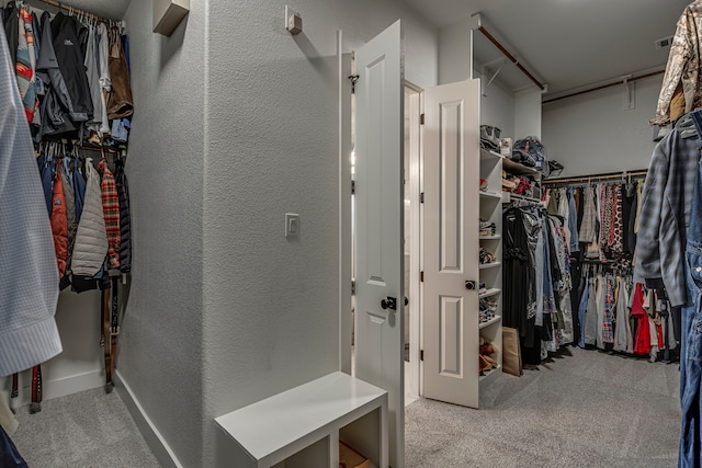 walk in closet with carpet floors