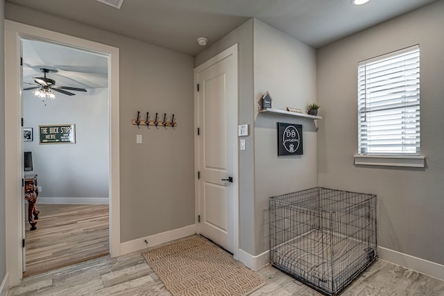 hall with light wood finished floors and baseboards