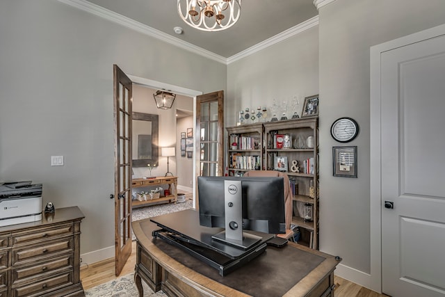 office area with baseboards, light wood-type flooring, an inviting chandelier, and crown molding