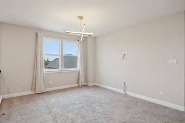 9814 Gristmill Ln, Frisco, TX 75035 - spare room featuring baseboards and carpet