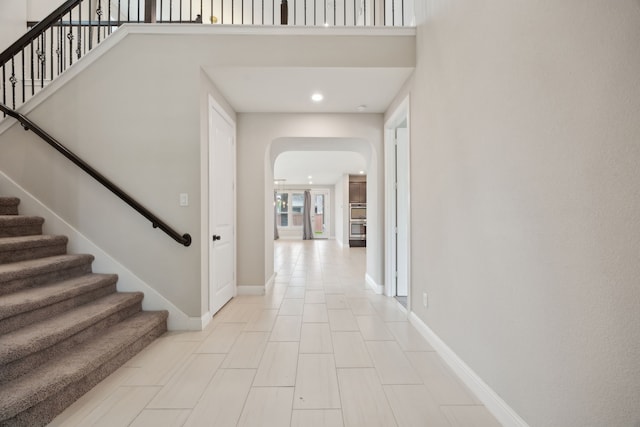 9814 Gristmill Ln, Frisco, TX 75035 - entryway with arched walkways, baseboards, stairs, and recessed lighting