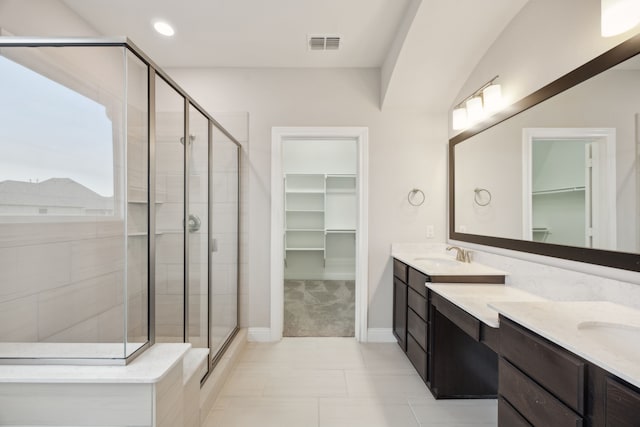 9814 Gristmill Ln, Frisco, TX 75035 - bathroom with a spacious closet, a shower stall, visible vents, and a sink
