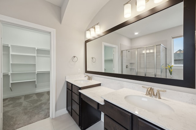 9814 Gristmill Ln, Frisco, TX 75035 - full bath featuring double vanity, a sink, a shower stall, and a walk in closet