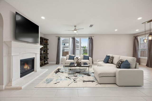 9814 Gristmill Ln, Frisco, TX 75035 - living area featuring a ceiling fan, a glass covered fireplace, visible vents, and recessed lighting