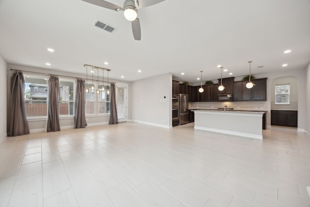 9814 Gristmill Ln, Frisco, TX 75035 - unfurnished living room with a sink, visible vents, recessed lighting, and ceiling fan