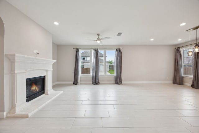 9814 Gristmill Ln, Frisco, TX 75035 - unfurnished living room featuring recessed lighting, a glass covered fireplace, visible vents, and a ceiling fan