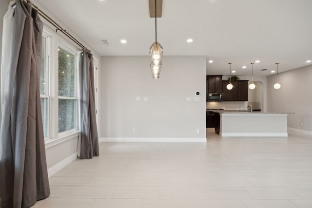 9814 Gristmill Ln, Frisco, TX 75035 - unfurnished living room with baseboards, a sink, visible vents, and recessed lighting