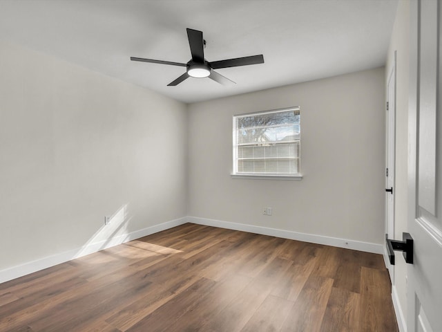 unfurnished room featuring baseboards, a ceiling fan, and dark wood-style flooring