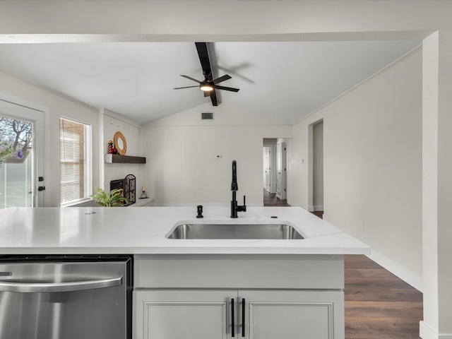 6916 Bennington Dr, Watauga, TX 76148 - kitchen with stainless steel dishwasher, a sink, ceiling fan, light countertops, and dark wood finished floors