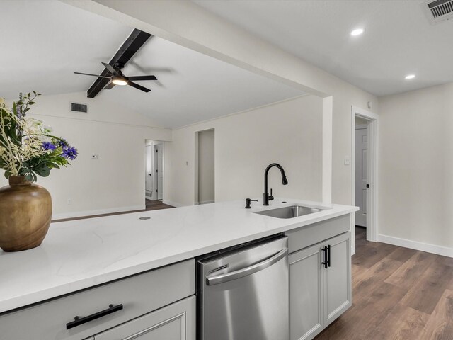 kitchen with lofted ceiling with beams, a sink, stainless steel dishwasher, visible vents, and dark wood-style floors