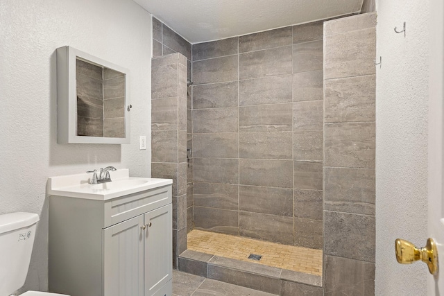 4131 Odessa St, Dallas, TX 75212 - bathroom featuring a textured wall, toilet, a walk in shower, and vanity