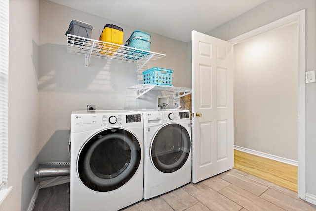 4131 Odessa St, Dallas, TX 75212 - laundry room with light wood finished floors, washing machine and dryer, baseboards, and laundry area