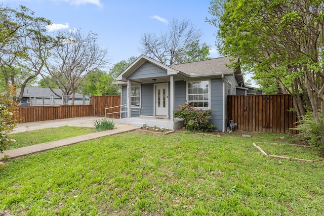 4131 Odessa St, Dallas, TX 75212 - bungalow-style home featuring a shingled roof, fence, a front lawn, and a porch