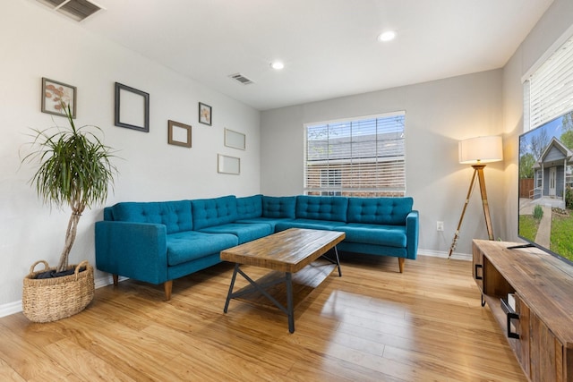 4131 Odessa St, Dallas, TX 75212 - living room with light wood-type flooring, a healthy amount of sunlight, and visible vents