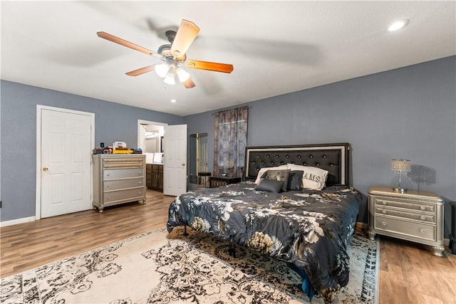 4520 Hiland Dr, Beverly Hills, TX 76711 - bedroom featuring a ceiling fan, ensuite bath, baseboards, and wood finished floors
