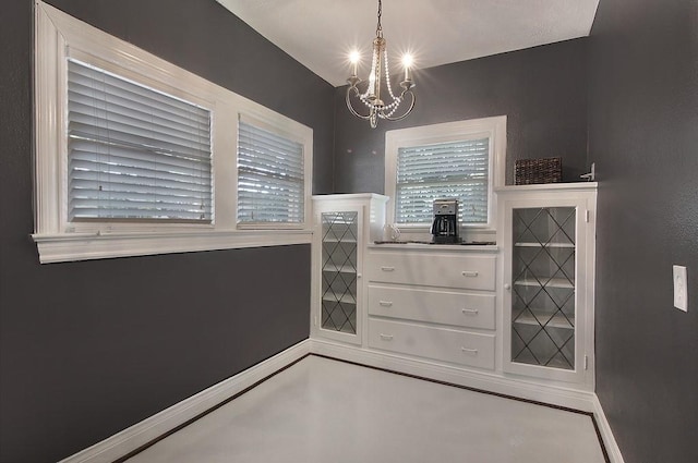 interior space with baseboards and an inviting chandelier