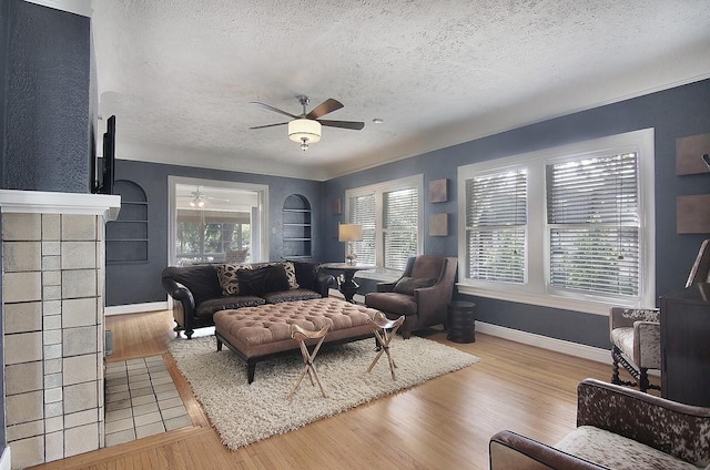 living room featuring wood finished floors, plenty of natural light, and ceiling fan
