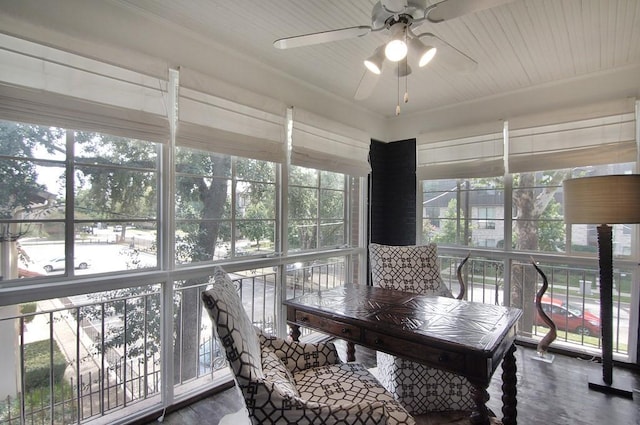 sunroom featuring a ceiling fan