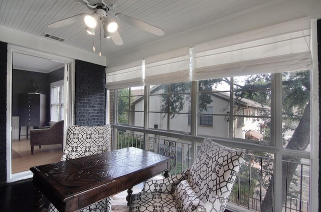 sunroom with visible vents and a ceiling fan