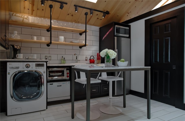 laundry area with track lighting, wooden ceiling, washer / dryer, and laundry area