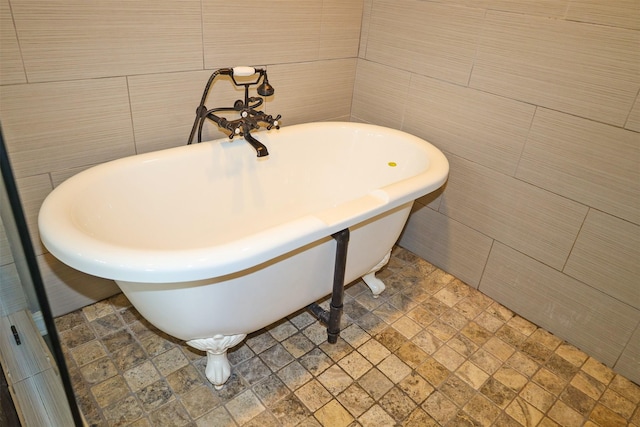 502 Parklane Dr, Bossier City, LA 71111 - bathroom featuring stone finish floor, a freestanding bath, and tile walls
