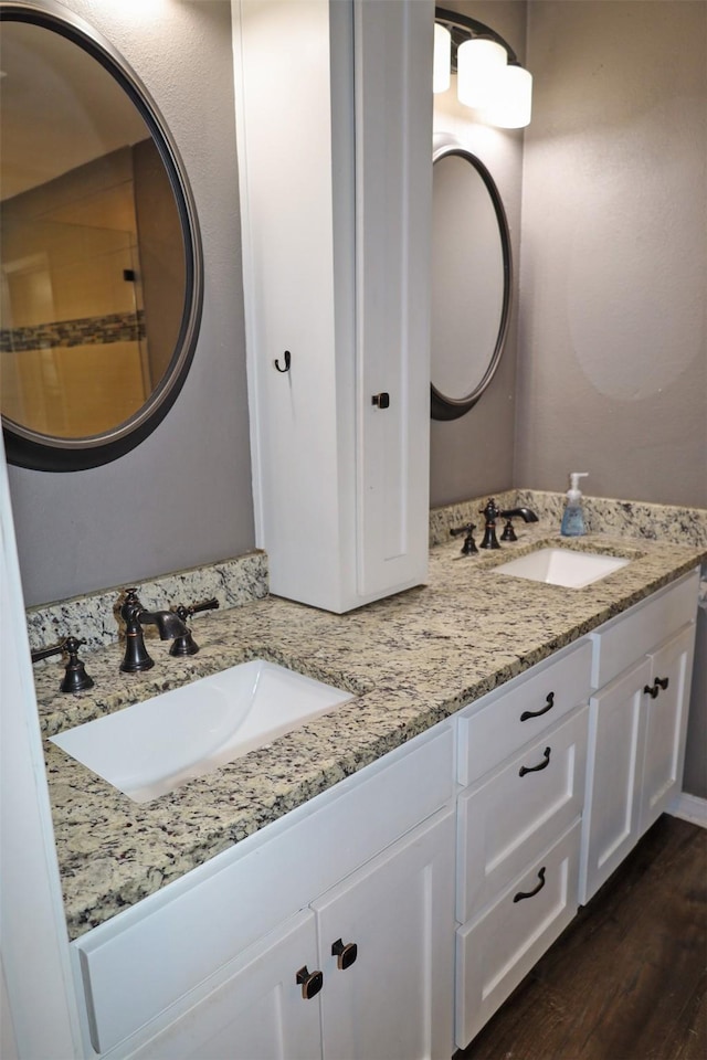 502 Parklane Dr, Bossier City, LA 71111 - full bath with double vanity, a sink, and wood finished floors