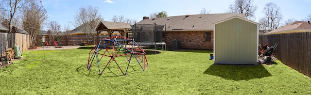 502 Parklane Dr, Bossier City, LA 71111 - view of playground featuring a trampoline, a fenced backyard, central air condition unit, and a yard