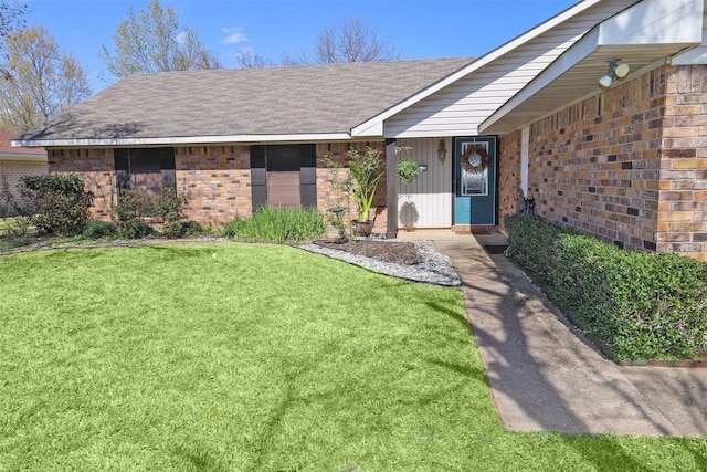 502 Parklane Dr, Bossier City, LA 71111 - property entrance featuring a lawn, brick siding, and roof with shingles