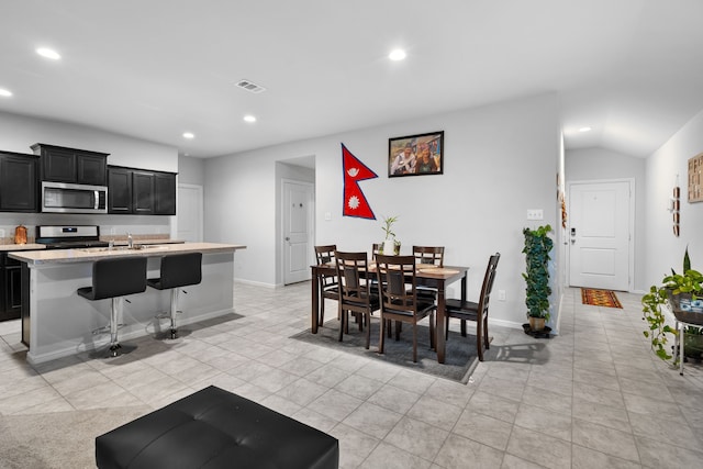 16617 Porterfield Ln, Justin, TX 76247 - dining area featuring recessed lighting, light tile patterned flooring, baseboards, and lofted ceiling