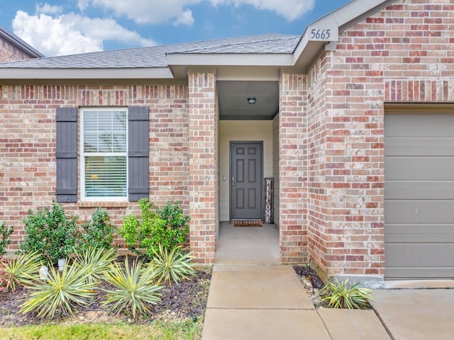 5665 Brownstone Ln, Fort Worth, TX 76036 - property entrance with brick siding and an attached garage