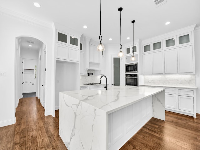 145 Fan Mill Trl, Weatherford, TX 76085 - kitchen with white cabinetry, wall oven, built in microwave, and arched walkways