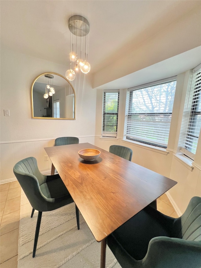 6225 Sunnybrook Dr, Watauga, TX 76148 - tiled dining space featuring a chandelier and wainscoting