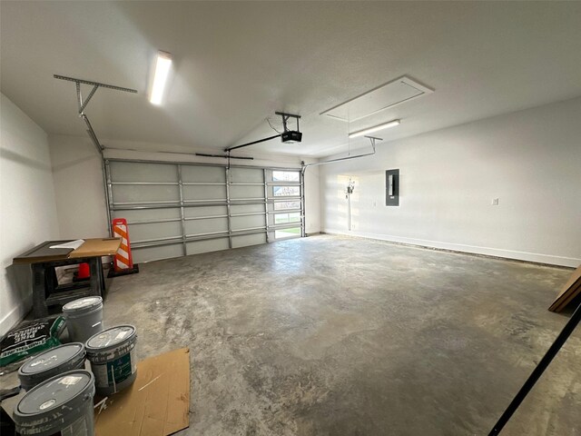 garage with a garage door opener and electric panel