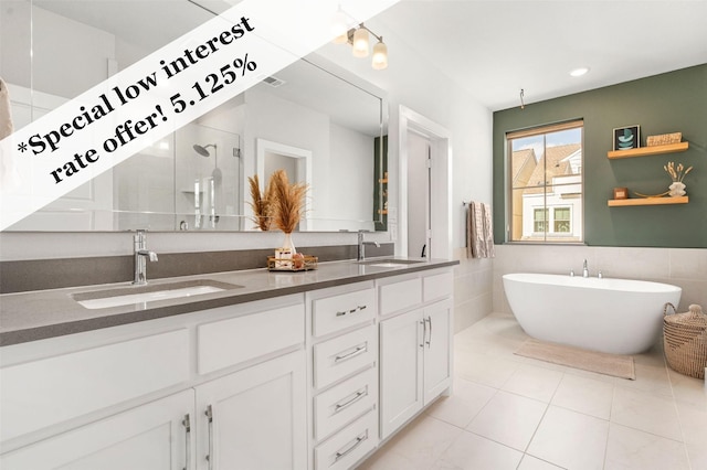 1065 Manacor Ln, Dallas, TX 75212 - full bathroom with a shower stall, a freestanding tub, double vanity, tile patterned flooring, and tile walls