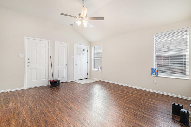 spare room featuring vaulted ceiling, a ceiling fan, baseboards, and wood finished floors