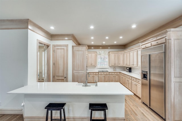 5709 Ridgehaven, Plano, TX 75093 - kitchen with built in refrigerator, a sink, a kitchen breakfast bar, light brown cabinetry, and recessed lighting