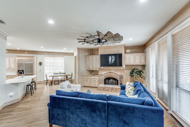 5709 Ridgehaven, Plano, TX 75093 - living area with light wood-type flooring, ornamental molding, recessed lighting, a fireplace, and baseboards