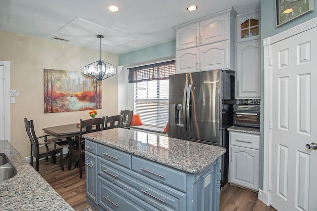 12073 Tyler Dr, Frisco, TX 75035 - kitchen featuring white cabinets, dark wood-type flooring, a chandelier, decorative light fixtures, and a center island