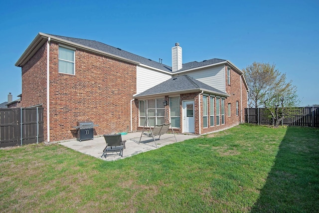 12073 Tyler Dr, Frisco, TX 75035 - rear view of house featuring brick siding, a patio area, and a chimney