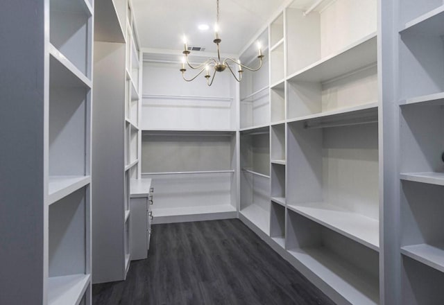 6609 Rockdale Rd, Fort Worth, TX 76134 - spacious closet with dark wood-style flooring, visible vents, and a notable chandelier