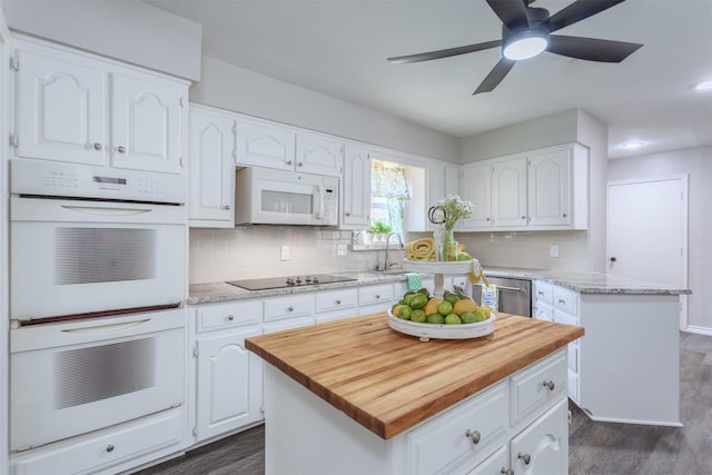 7 Harolds Cir, Richardson, TX 75081 - kitchen with white appliances, white cabinetry, dark wood finished floors, and wooden counters
