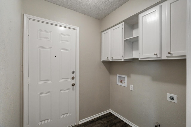 laundry room with a textured ceiling, dark wood finished floors, baseboards, cabinet space, and electric dryer hookup
