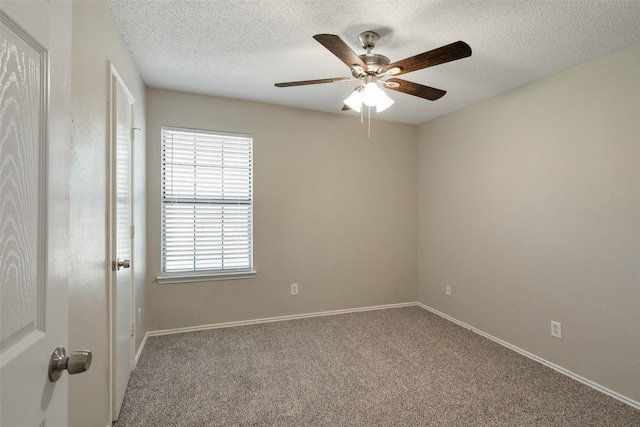 carpeted empty room featuring a textured ceiling, baseboards, and ceiling fan
