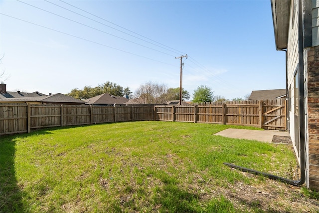 view of yard with a fenced backyard