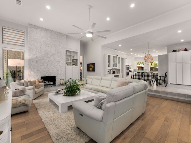 living room with recessed lighting, ceiling fan, and light wood-style flooring