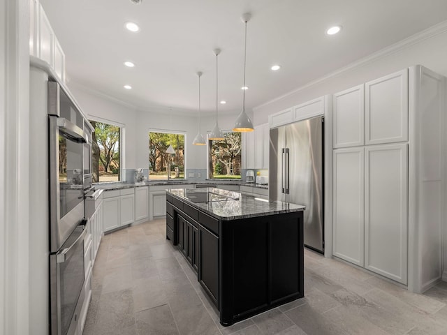 kitchen featuring stainless steel fridge, recessed lighting, light stone counters, and a kitchen island