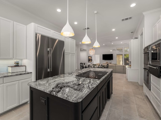 kitchen with white cabinets, black electric cooktop, open floor plan, a kitchen island, and high quality fridge