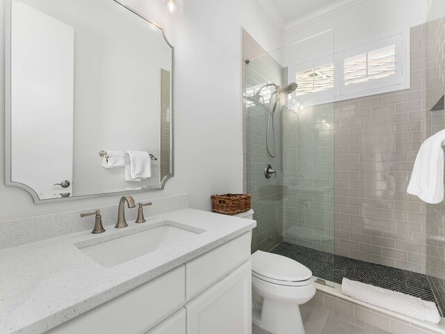 full bathroom featuring crown molding, walk in shower, toilet, and vanity
